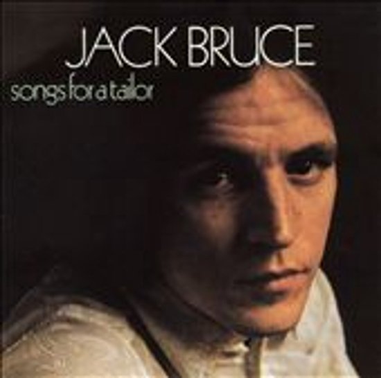 Jack Bruce, Songs for a Tailor albumhoes. Close-up portret van een man met een donkerbruine huid en lichte huid. Hij draagt een wit overhemd en bretels.