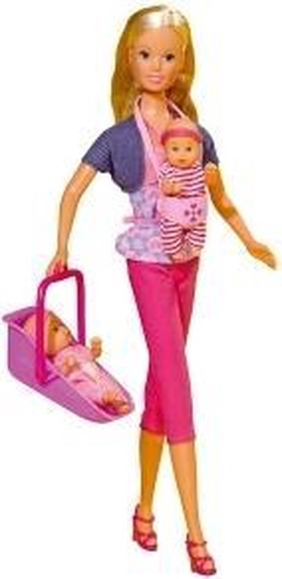 Steffi Love pop met baby in draagzak en een baby in roze reiswieg. Steffi draagt een paarse bolero, roze broek en top met stippen.