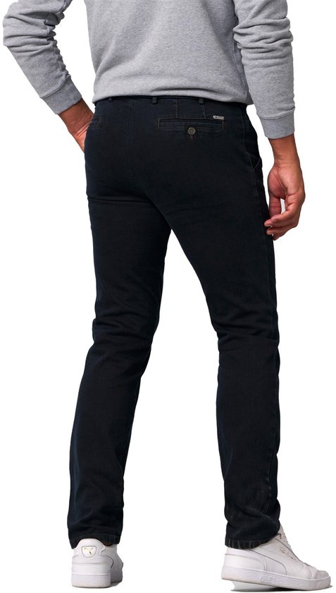 Man met de rug naar de kijker, draagt donkerblauwe jeans en witte sneakers.