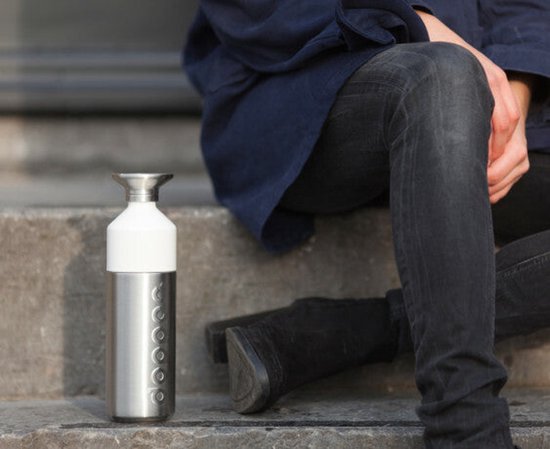 Dopper en acier inoxydable avec bouchon blanc, assis sur une marche.