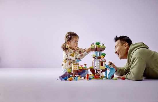 Vader en kind spelen samen met de LEGO DUPLO 3in1 Boomhut speelset.