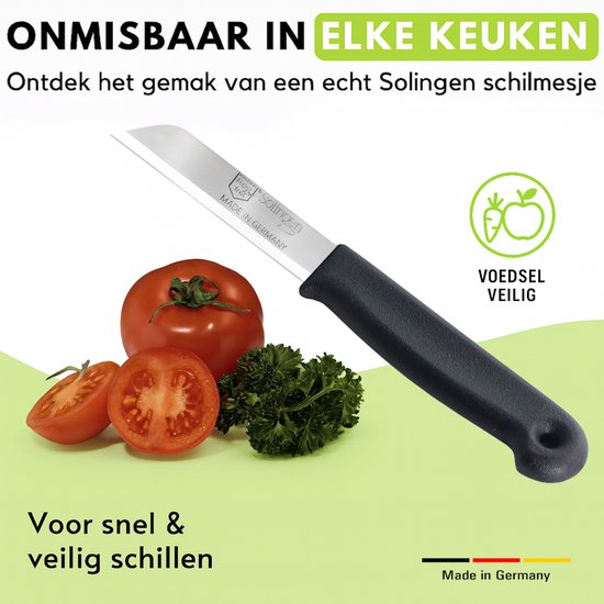 Zwart Solingen schilmesje naast tomaat, peterselie en komkommer. 'Voedselveilig'.