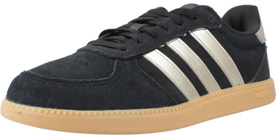 Zwarte Adidas sneaker met gouden strepen en gummi zool.