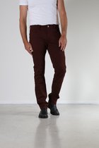 Man, staand van voren, draagt een bordeauxrode broek en zwarte schoenen.