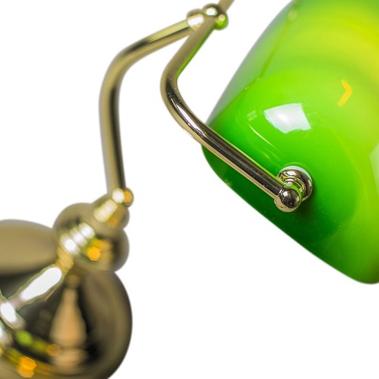 Gros plan du bras doré et de la fixation de l'abat-jour vert.