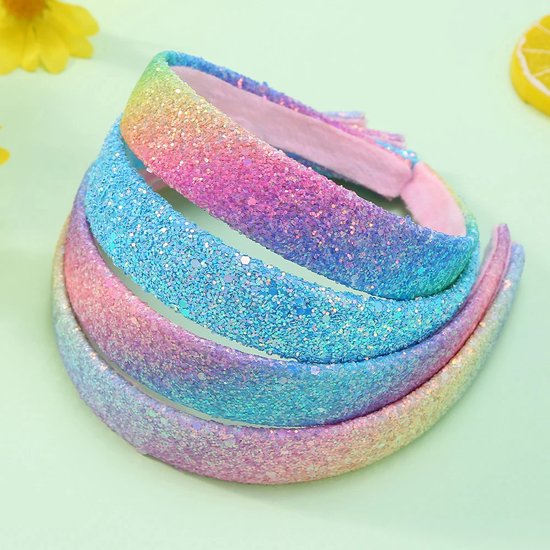 Drie glitter haarbanden in regenboogkleuren, gestapeld.