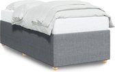 Cadre de lit en tissu gris côtelé, avec un matelas et des draps blancs dessus.