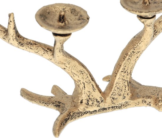 Gouden gewei kandelaar detail, met ruw, verweerd uiterlijk.