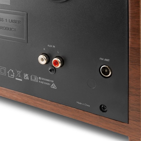 Close-up van de achterkant van de Audizio radio: houten afwerking met AUX IN en FM ANT aansluitingen.