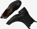 Zwarte leren Chelsea boots, van bovenaf gezien met de zolen naar elkaar toe.