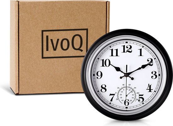 Zwarte wandklok met witte wijzerplaat en thermometer, 30 cm, naast kartonnen doos