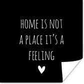 Poster Engelse quote "Home is not a place it's a feeling" met een hartje tegen een zwarte achtergrond - 30x30 cm